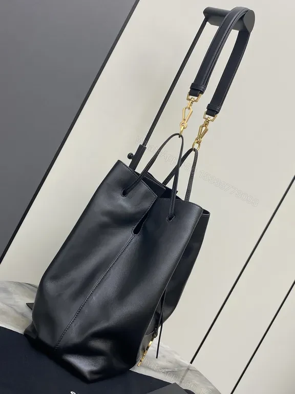 View 5 of Minimalist Black Leather Drawstring Bucket Bag with Gold Hardware