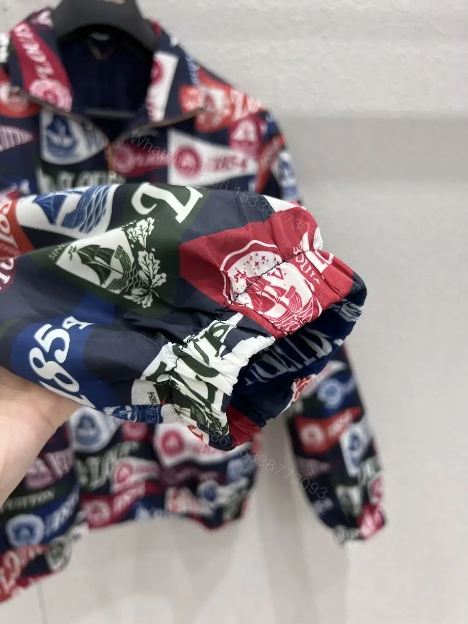 View 5 of Bold Patterned Zip Jacket: Logo Motif Luxury Streetwear