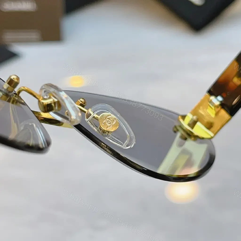 View 8 of Luxurious Silver-Gray Sunglasses: Gold Accents, Semi-Rimless Oval, Chanel Hardware