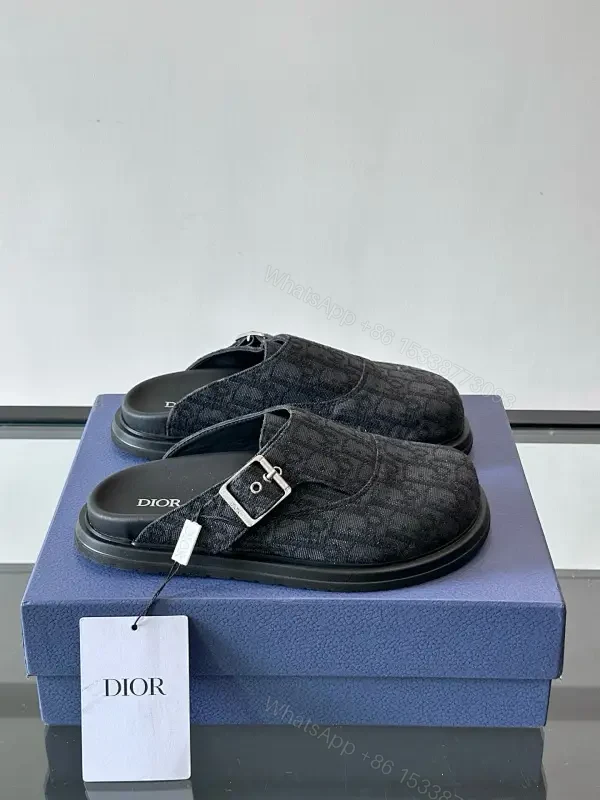 Dark Monogram Slip-Ons: Textured Mules with Subtle Buckle — view 1