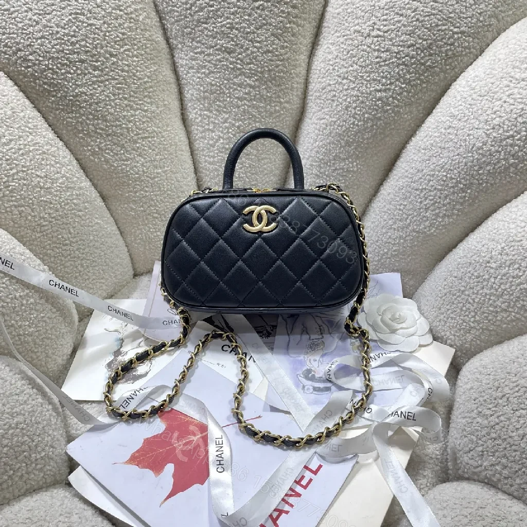 Compact Black Quilted Handbag with Gold Logo Chain — view 1