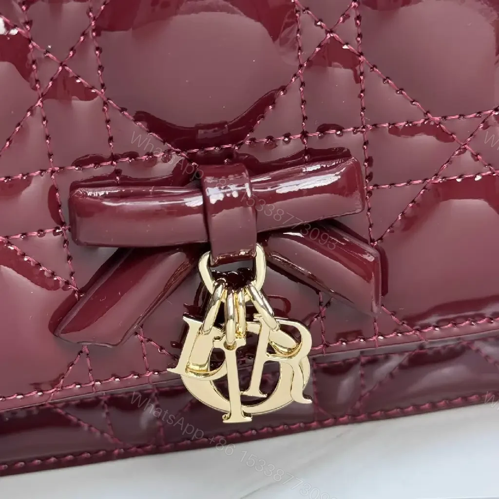 View 3 of Glossy Burgundy Quilted Mini Bag with Bow Accent