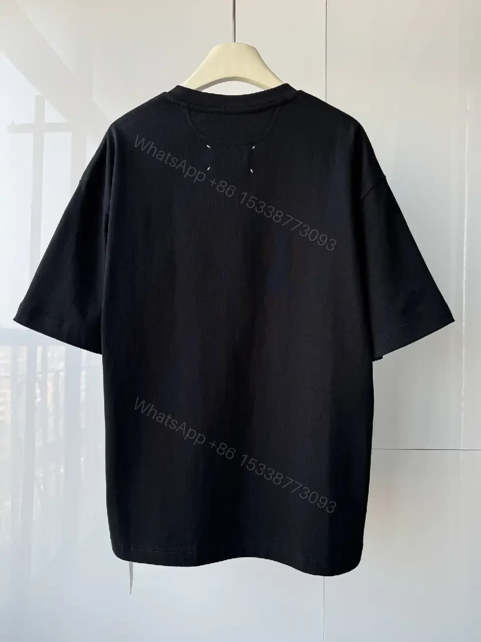 View 3 of Oversized Black Tee with Embossed Numeric Grid - Modern Graphic Comfort