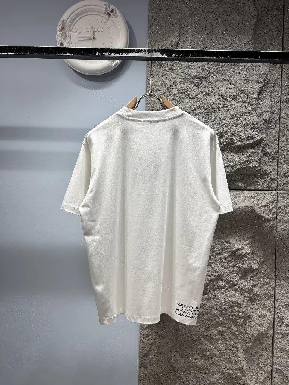 View 9 of Minimalist White T-Shirt with Subtle LV.M Emblem - Premium Cotton