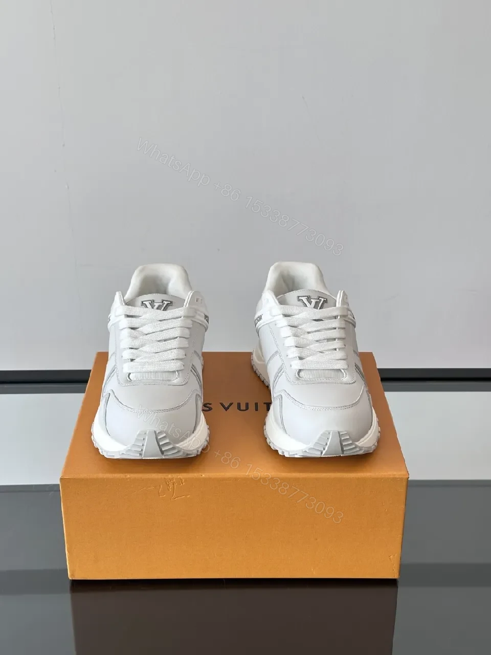 View 4 of Minimalistic White Leather Sneakers with Subtle Texture and Monogram Accent