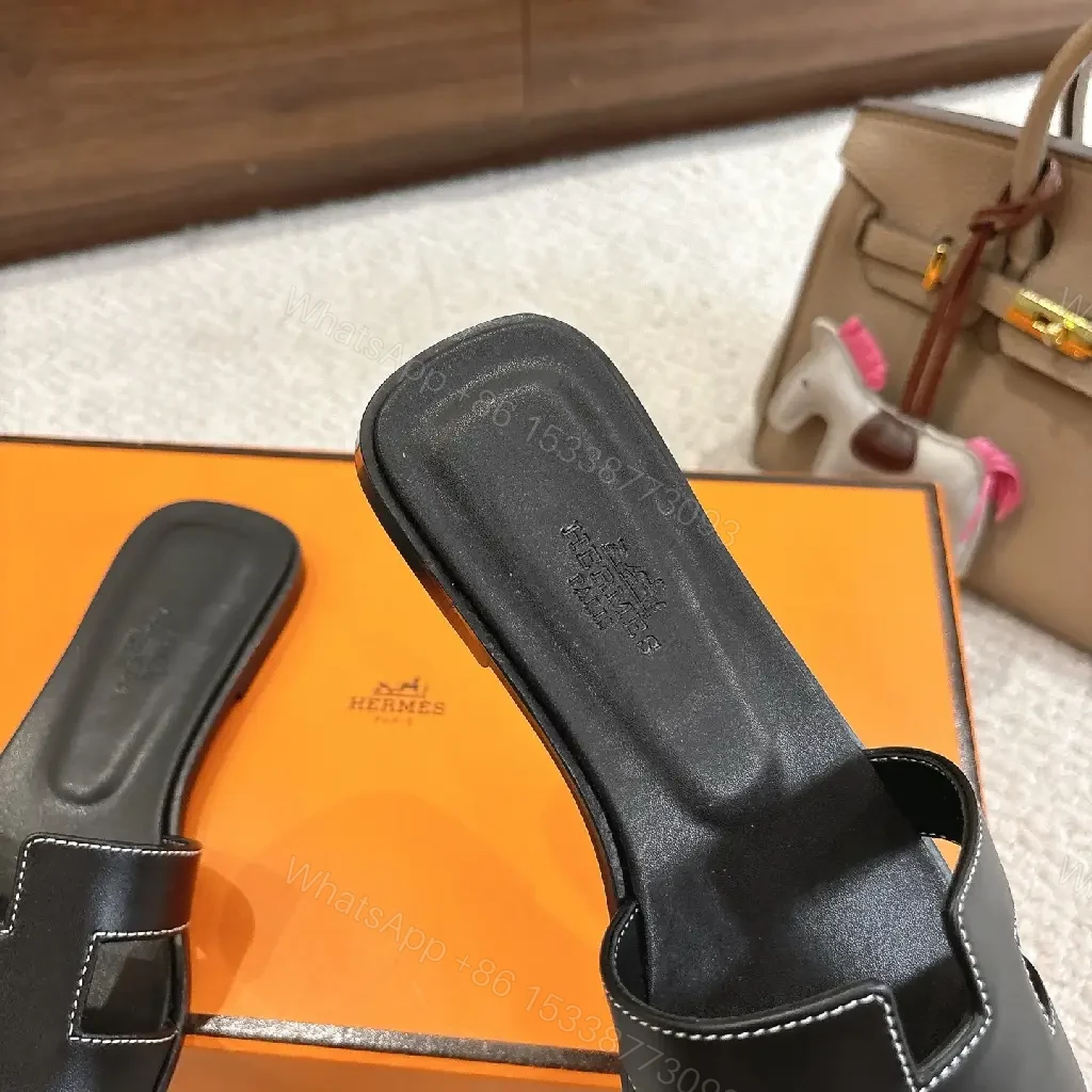 View 6 of black leather slide sandals with H-shaped buckles for luxury everyday