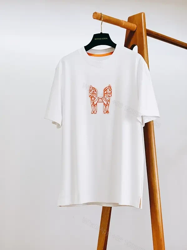 Minimalist White Tee with Bold Orange Emblem T-Shirt — view 1