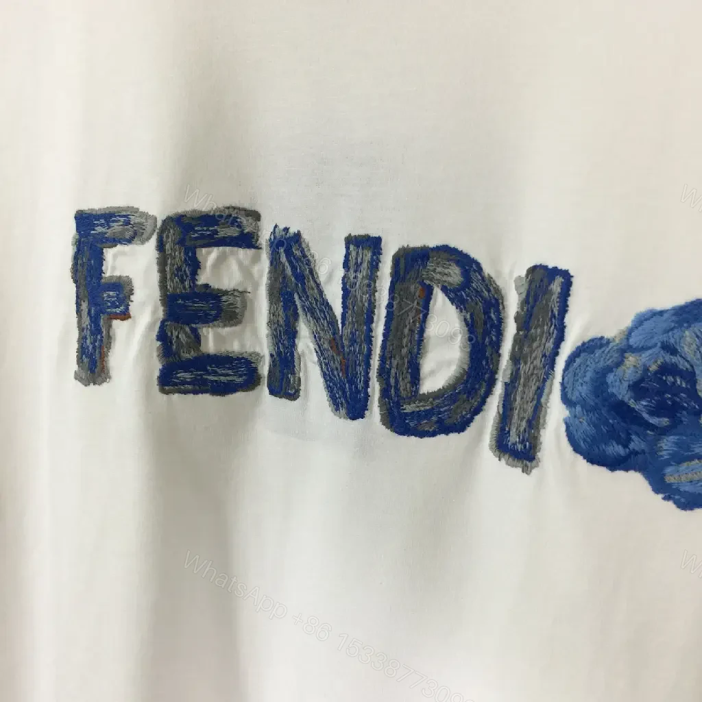 View 2 of White Cotton/Poly blend Short-sleeve Crew Neck Bold FENDI logo with blue flower T-shirt