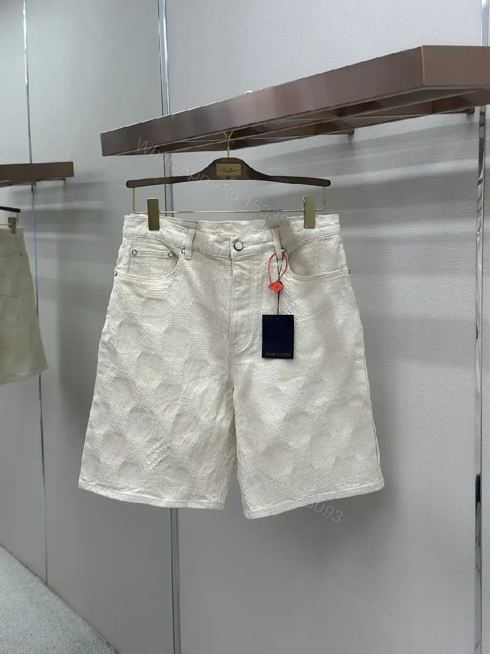 View 2 of Beige textured cotton-blend shorts with monogram-inspired print for everyday luxury