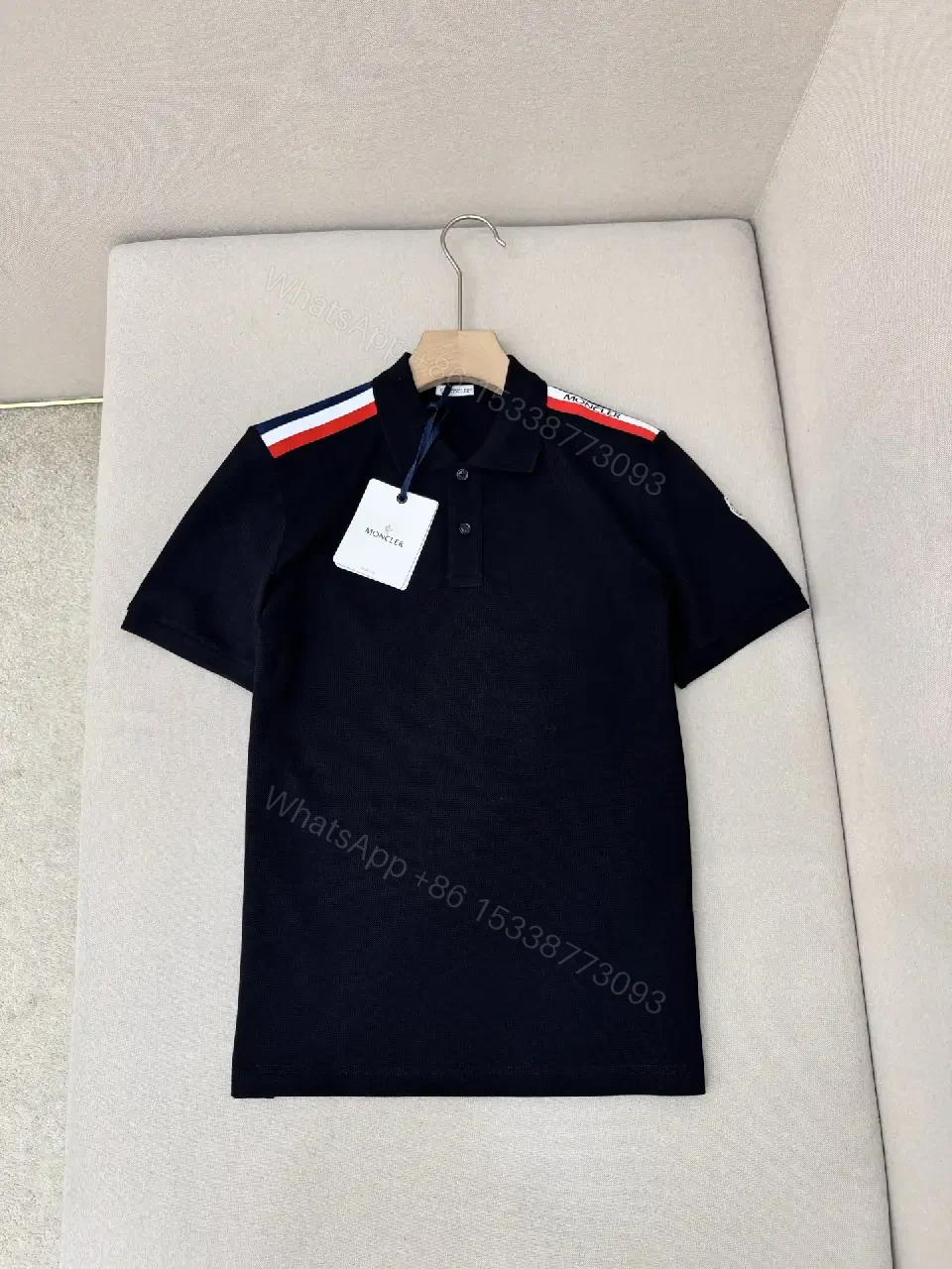 View 9 of Navy cotton polo shirt with red-white striped shoulder accents for everyday luxury