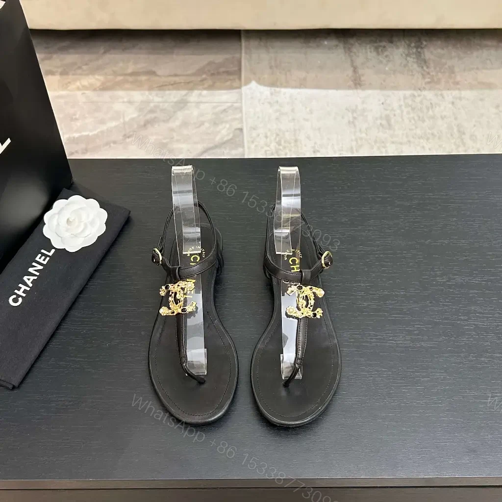 View 5 of Minimalist Black Leather Sandals with Gold Charms - Elegant Comfort
