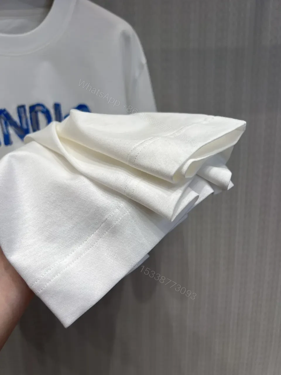 View 6 of Minimalist White Tee with Luxe Embroidered Logo, Casual-Ready Top