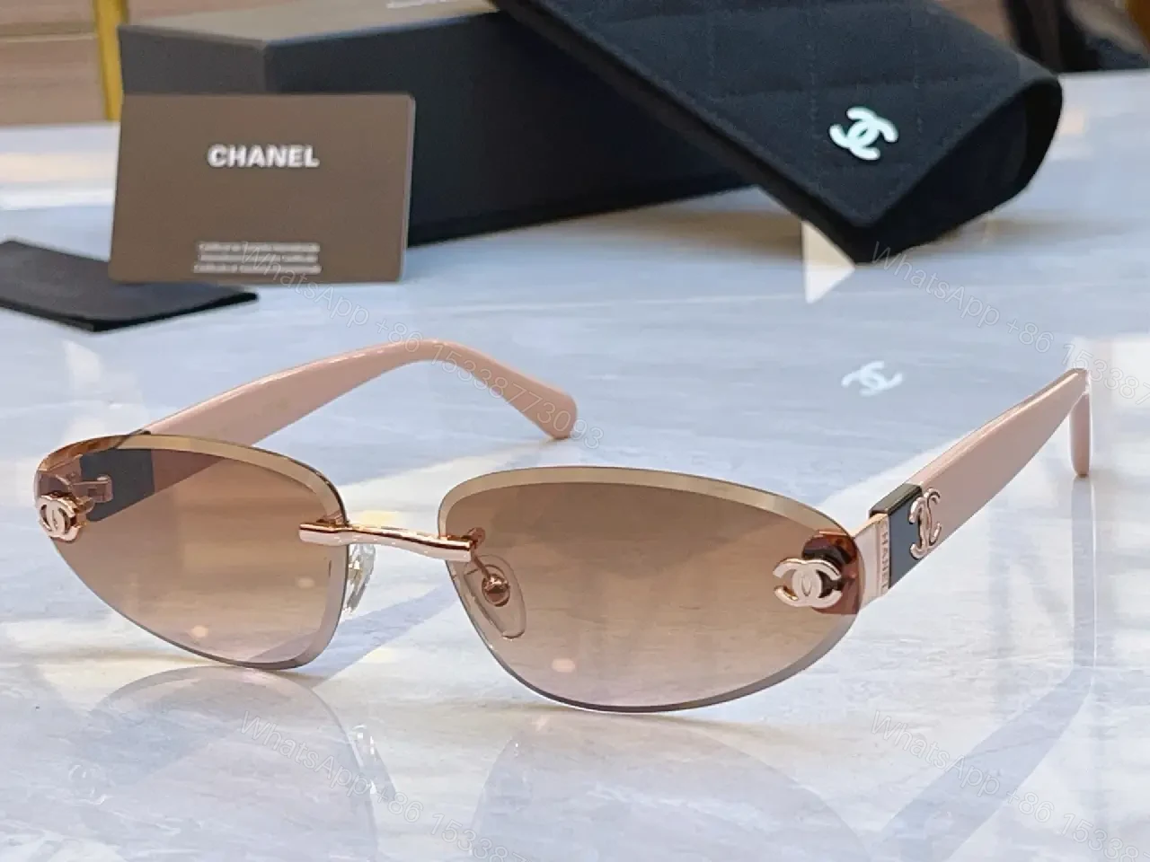 View 10 of Luxurious Silver-Gray Sunglasses: Gold Accents, Semi-Rimless Oval, Chanel Hardware