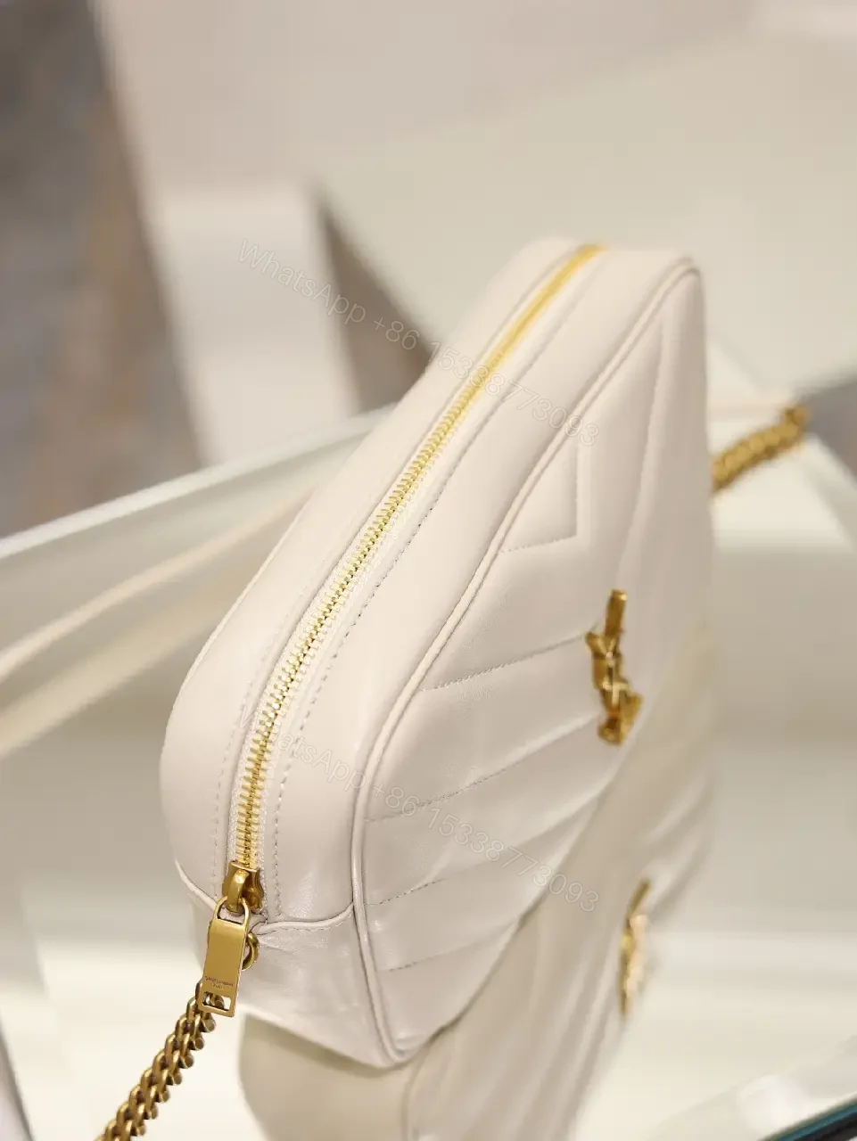 View 3 of Off-White Cream Quilted Chevron Crossbody Bag with Gold Logo