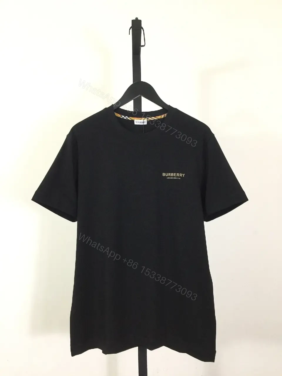 View 4 of Minimalist Black Cotton Tee, Subtle Logo, Everyday Comfort