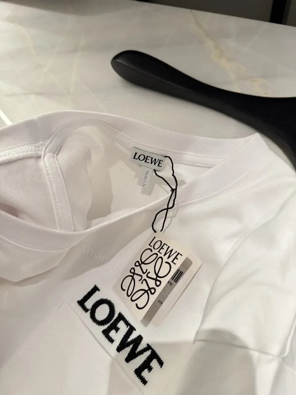 View 3 of Minimalist White Tee with Structured Pocket & Logo Emblem