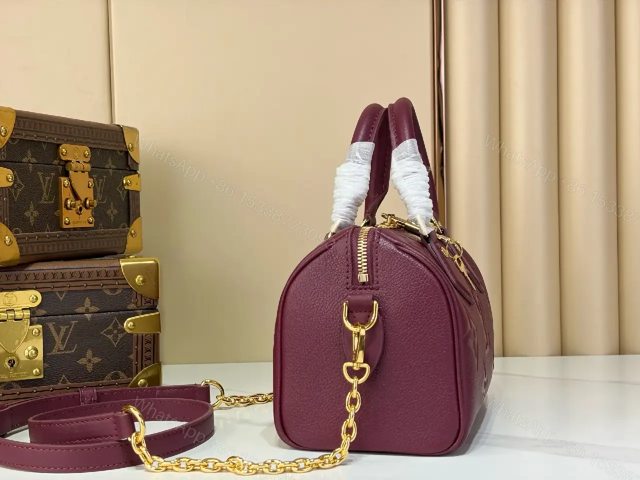 View 7 of Deep Plum Leather Satchel: Structured Top-Handle Bag with Embossed LV Motifs