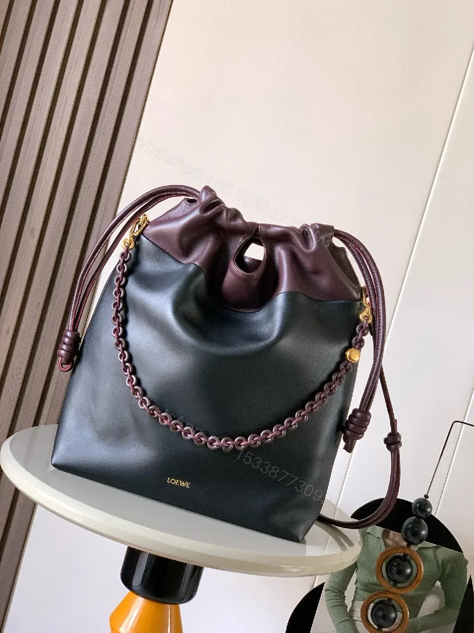 Two-Tone Leather Drawstring Bucket Bag with Chain Detail — view 1