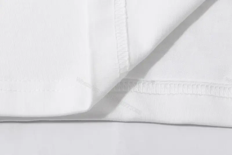 View 8 of Minimalist White Tee: Premium Cotton, Subtle Logo, Everyday Luxury