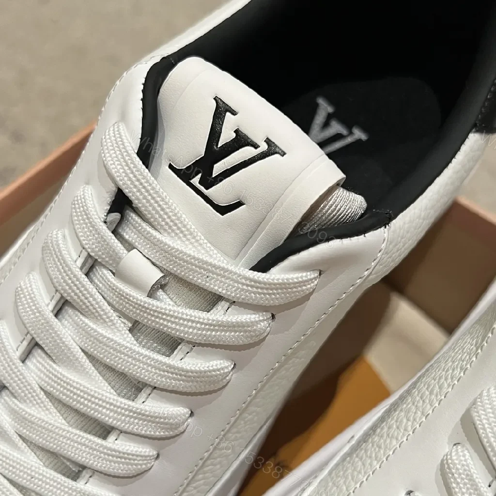 View 3 of Minimalist White Leather Sneakers with Signature Detail - Modern Luxury