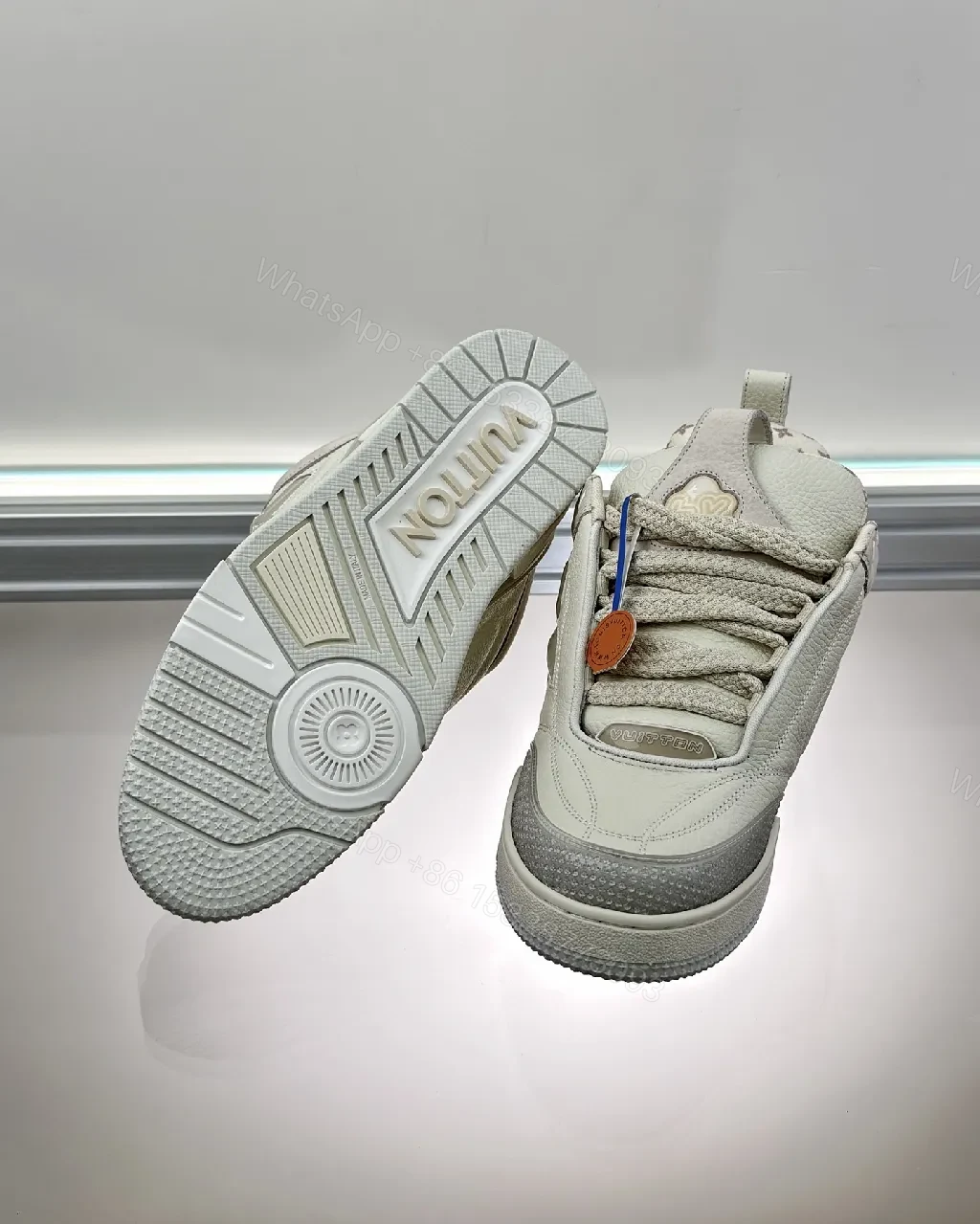 View 6 of Textured White Leather Sneakers with Signature Motif, Modern Luxury