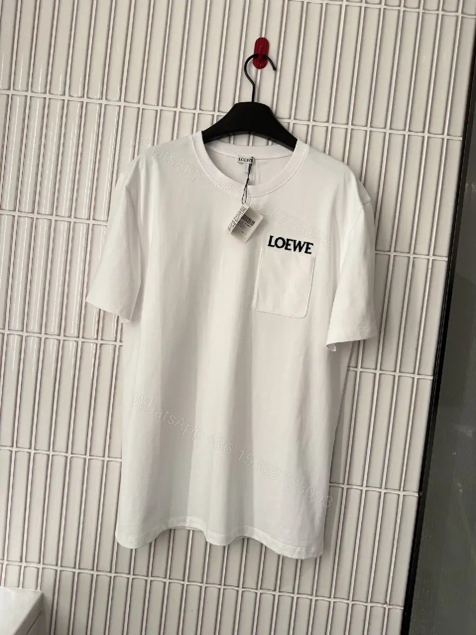 Minimalist White Tee with Structured Pocket & Logo Emblem — view 1