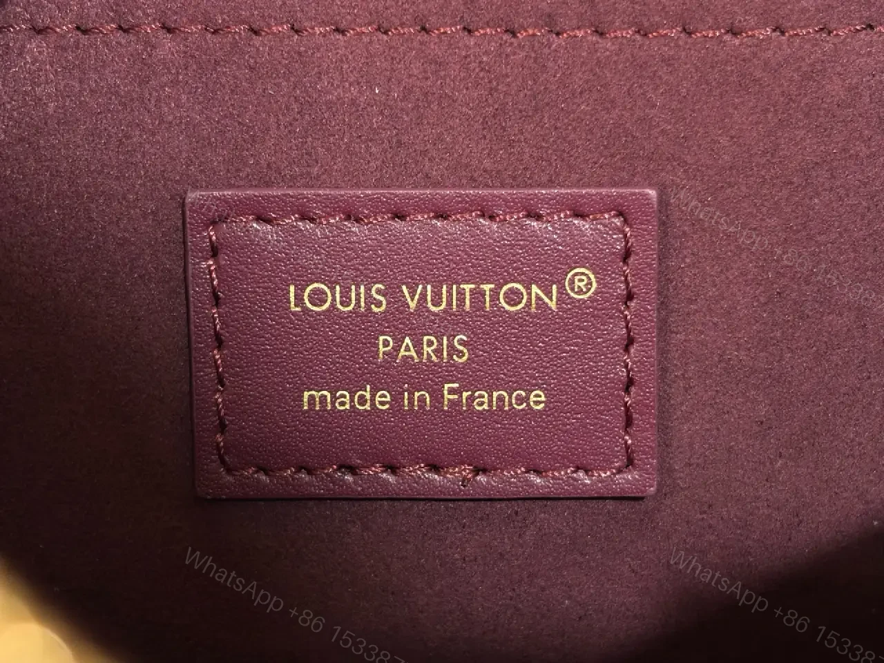 View 5 of Deep Plum Leather Satchel: Structured Top-Handle Bag with Embossed LV Motifs