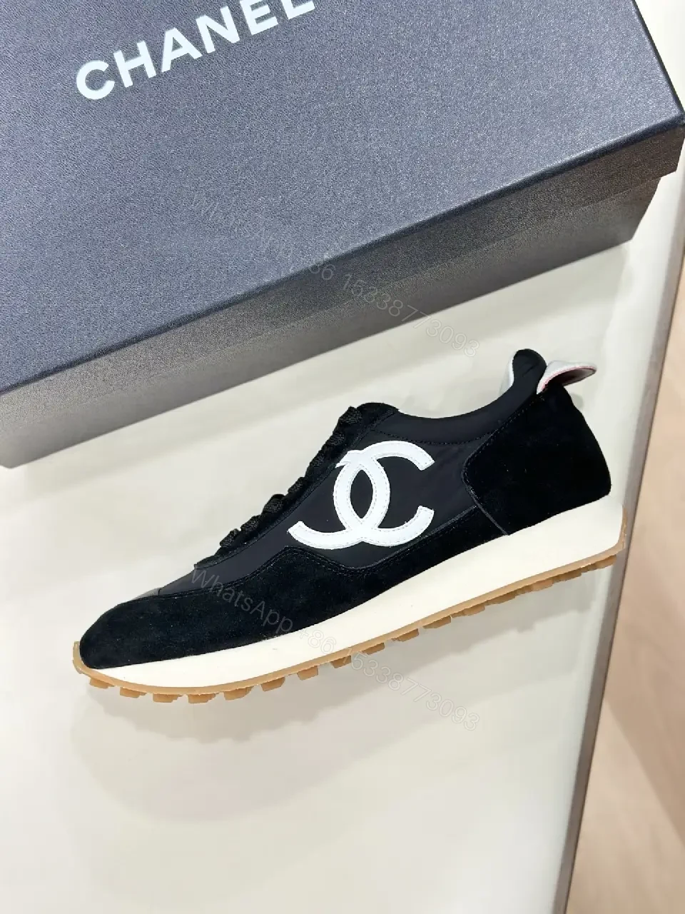 View 6 of Sleek Black Knit High-Top Sneaker with Signature Emblem, Luxury