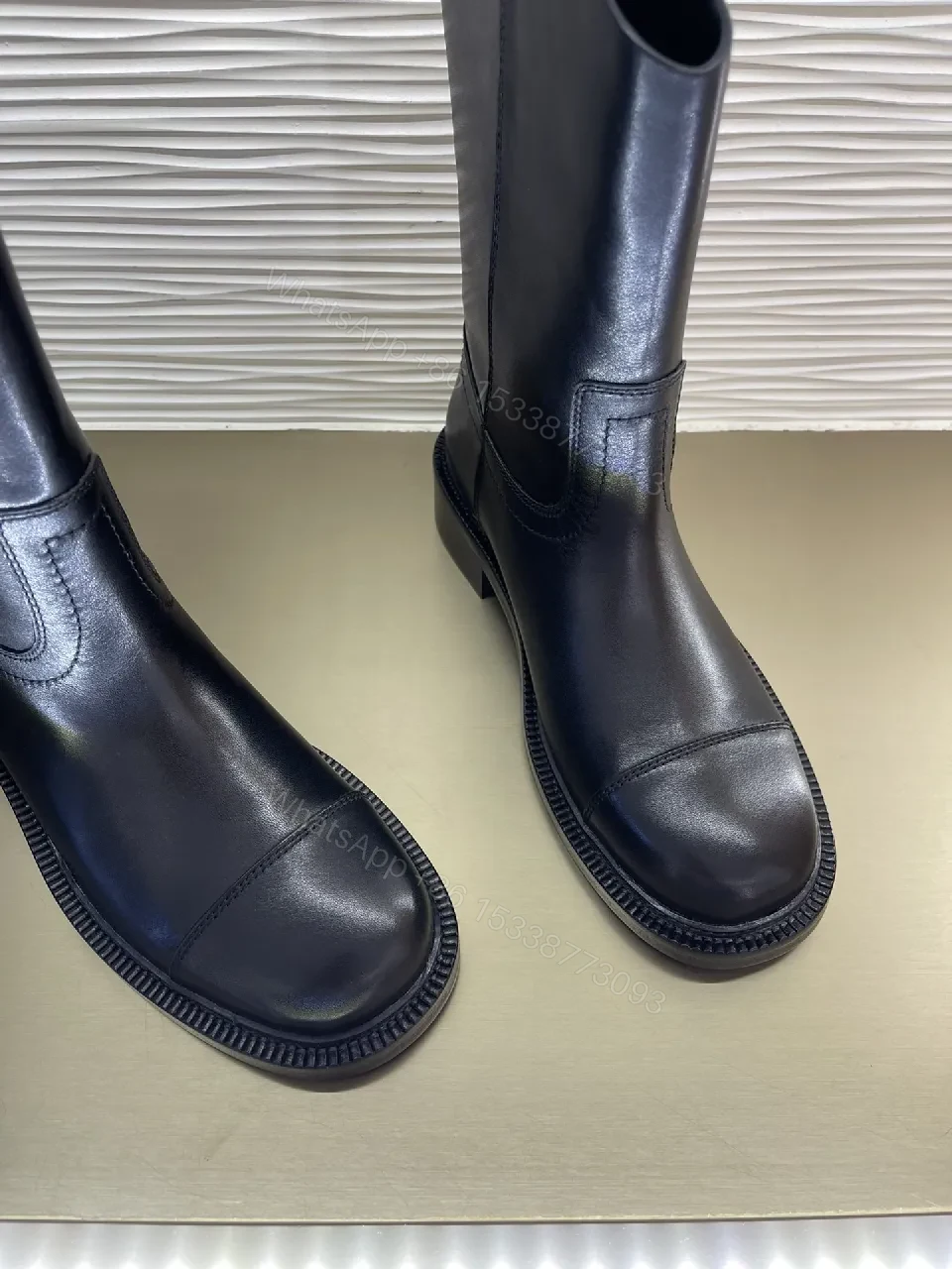 View 7 of Chic Black Leather Knee-High Boots with Logo Embellishment