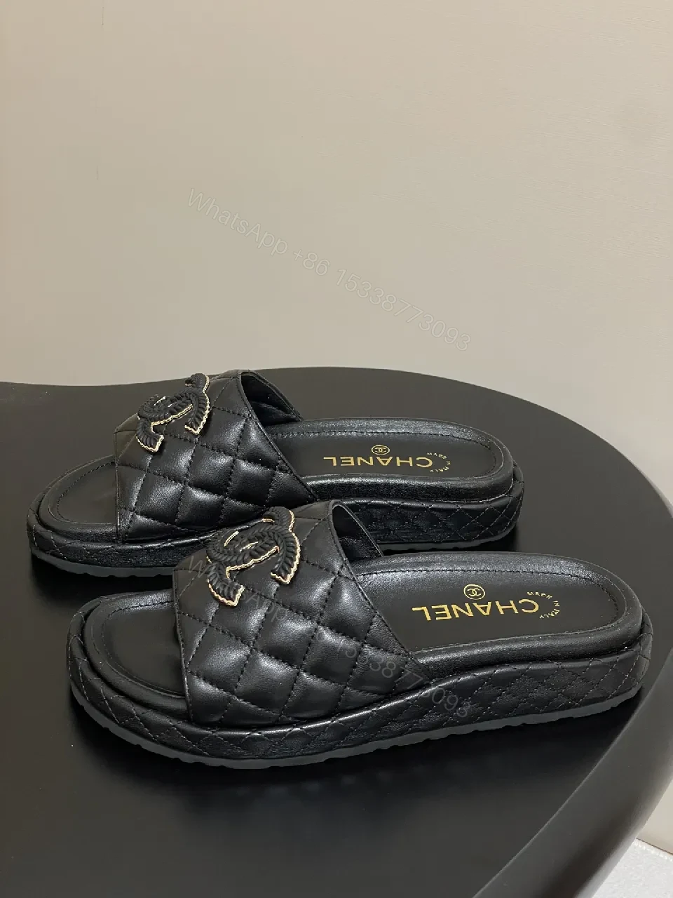 View 7 of Quilted Black Slip-Ons with Gold Emblem – Luxe Style
