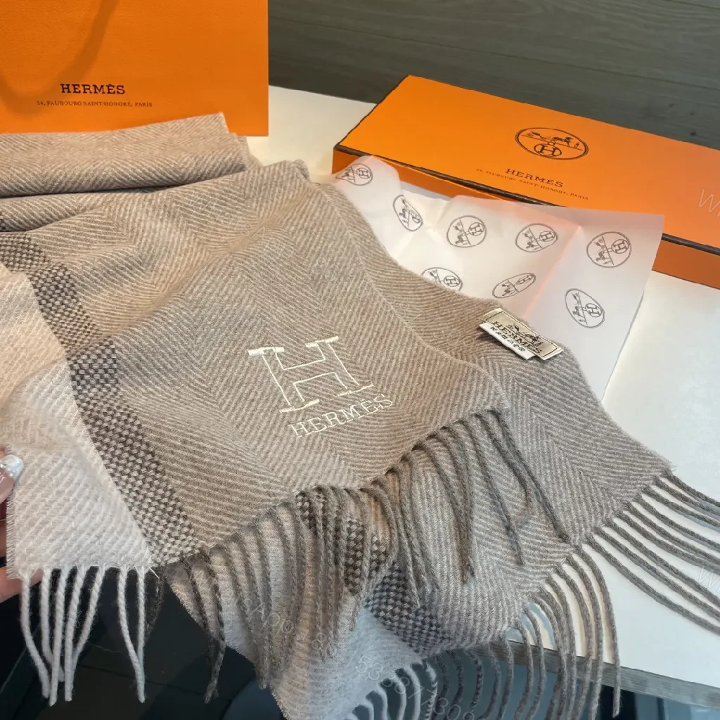 View 8 of Neutral Herringbone Knit Scarf with Subtle Emblem Detail
