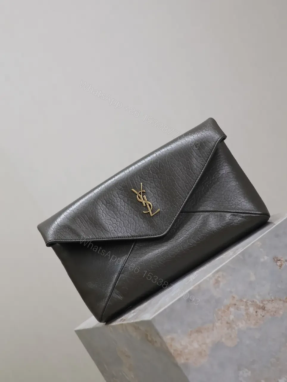 View 9 of Textured Black Leather Envelope Clutch with Gold Logo Signature