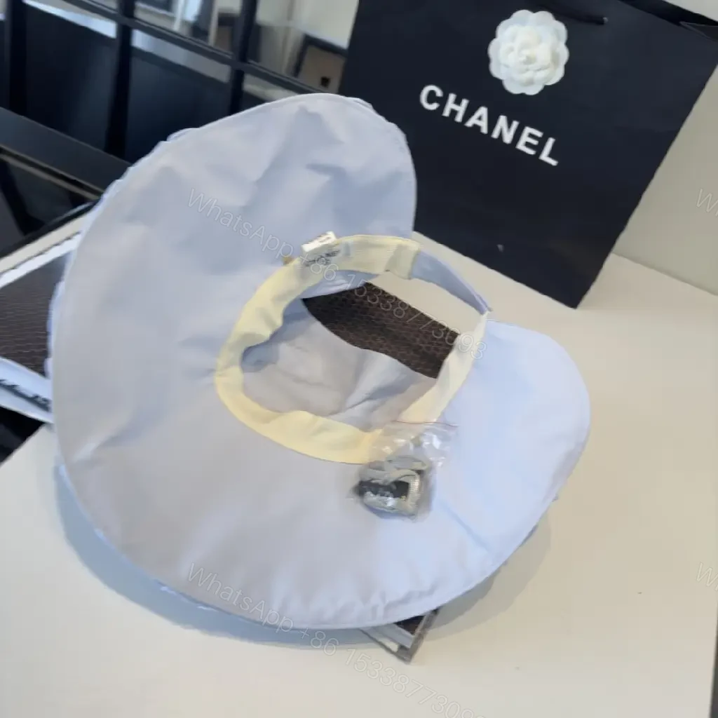 View 7 of Pastel Blue Floppy Hat with Ruffled Brim & Chanel Charm