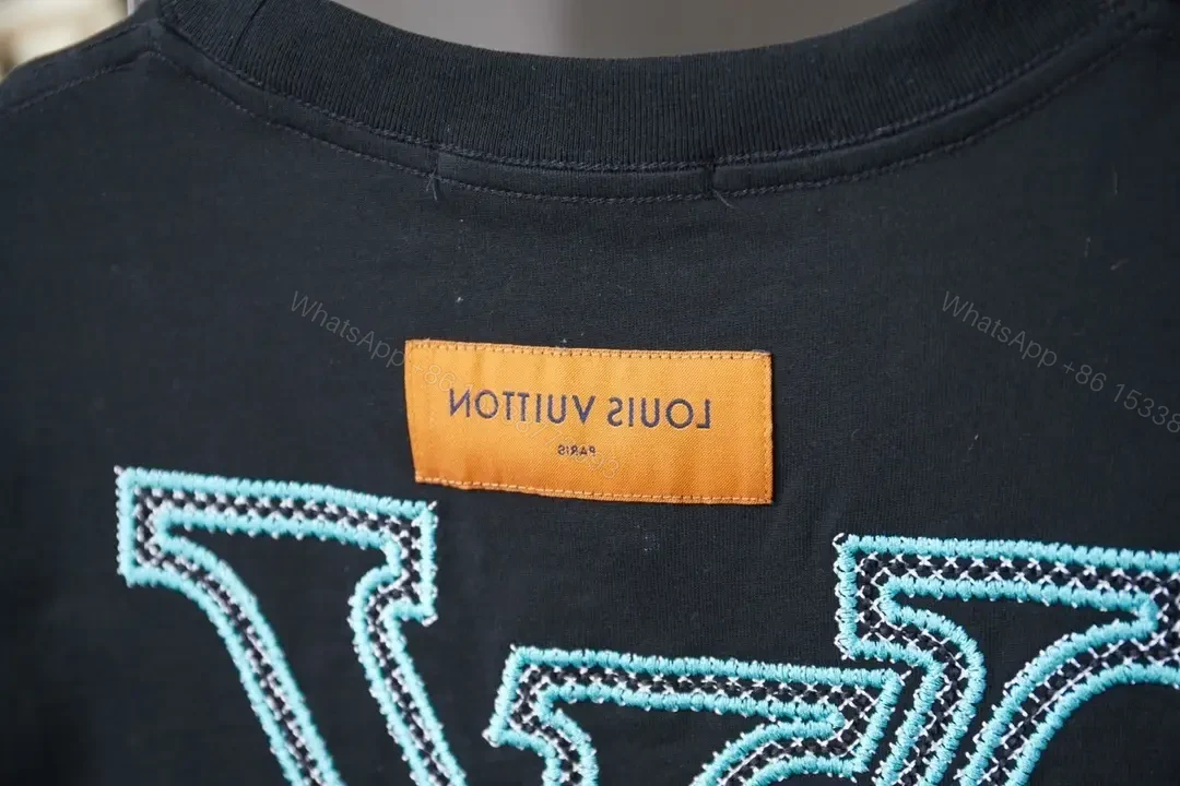 View 6 of Black Cotton Tee with Teal Embroidered Logo Accent, Minimalist Style, Everyday Luxury Tee