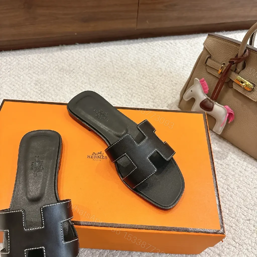 View 4 of black leather slide sandals with H-shaped buckles for luxury everyday
