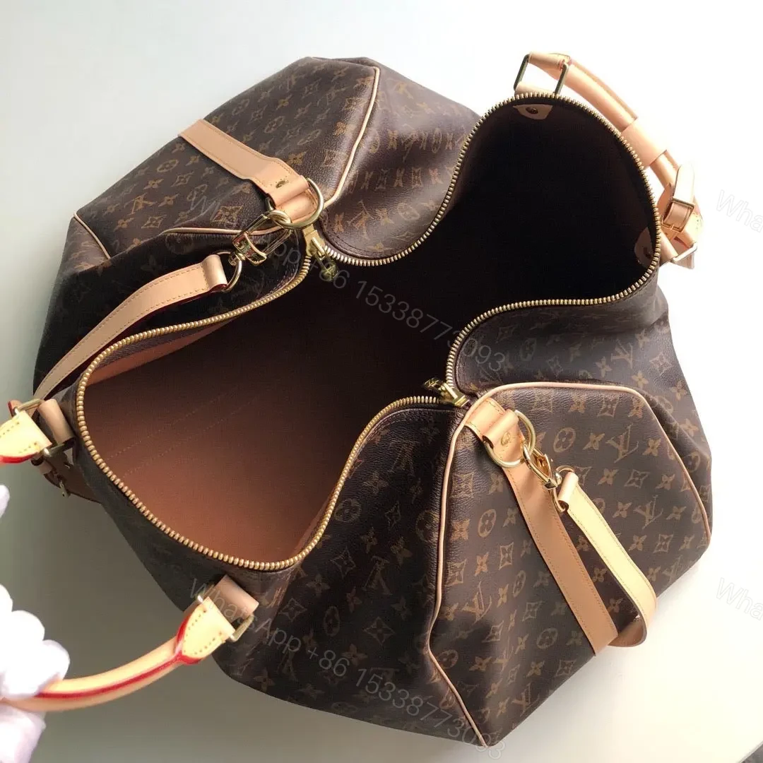 View 3 of LV Monogram Canvas Keepall Bandoulière 55 Leather Duffle Bag