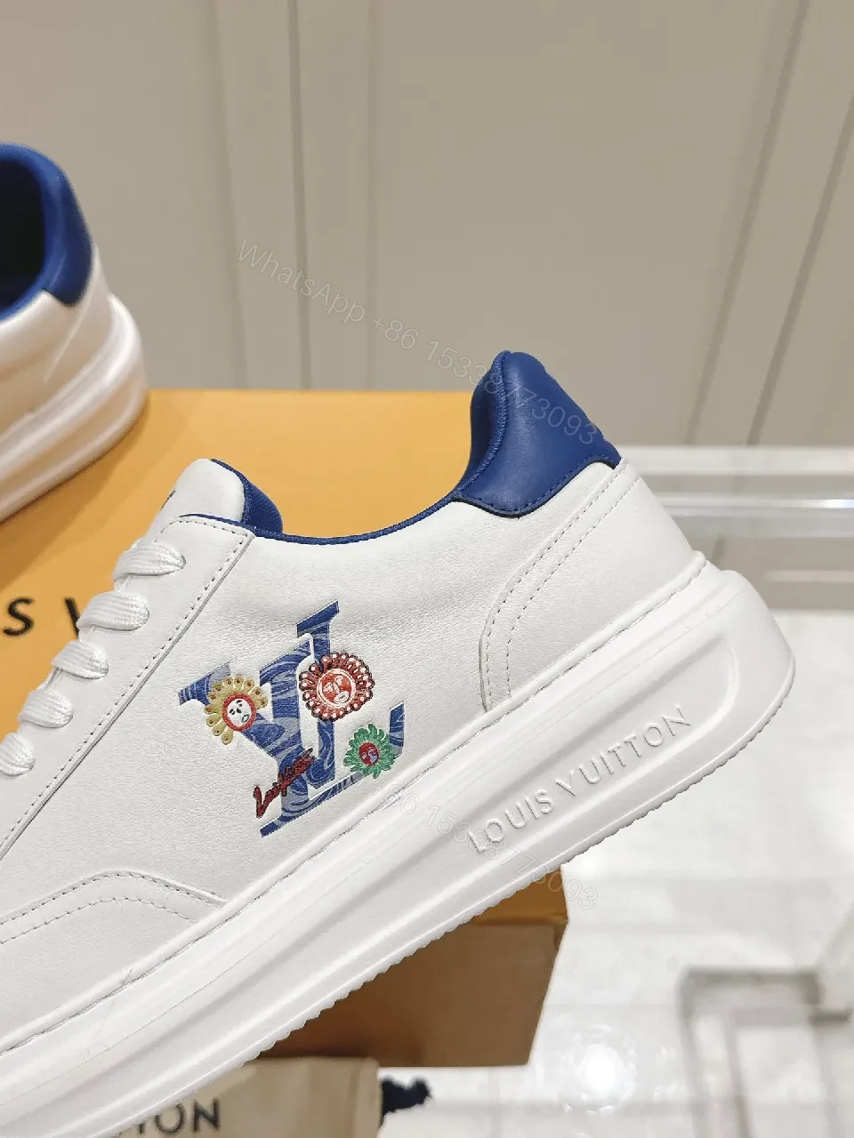 View 2 of Clean White Leather Low-Top Sneakers with Subtle Designer Embellishments
