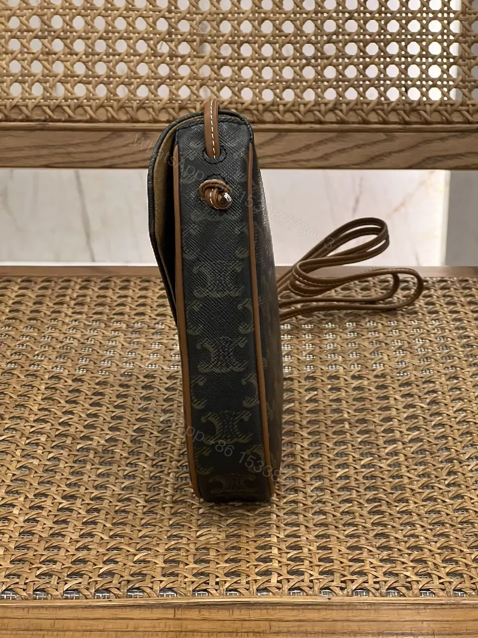 View 6 of Chic Black Monogram Cocoon Bag: Compact Luxury Crossbody