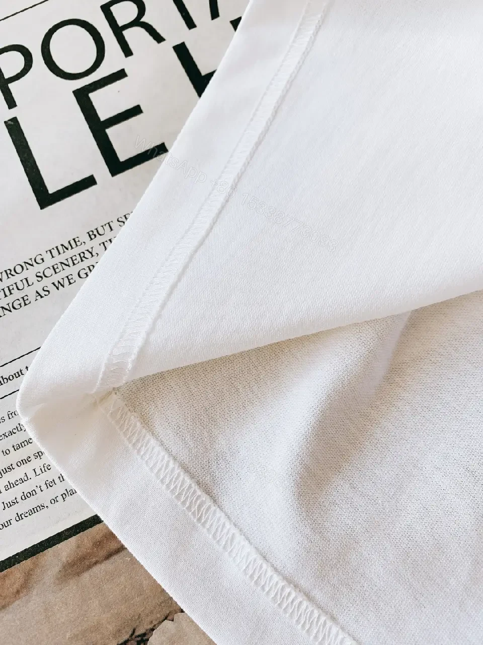 View 2 of White Cotton Logo Tee – Modern Luxury Essential T-Shirt