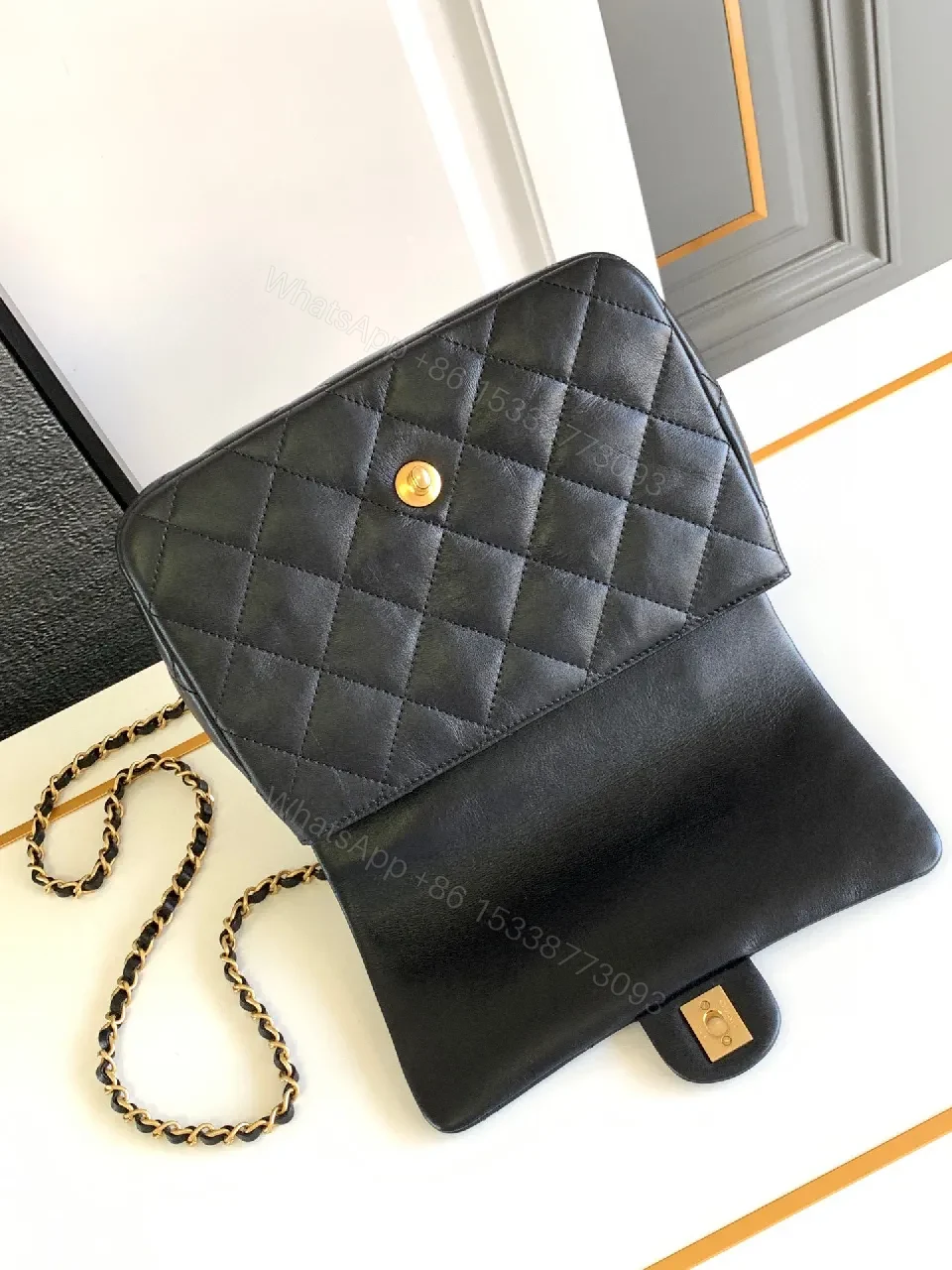 View 7 of Compact Dark Leather Quilted Flap Bag with Gold Hardware