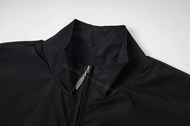 View 9 of Minimalist Black Windbreaker: Subtle Branding, All-Season Outerwear