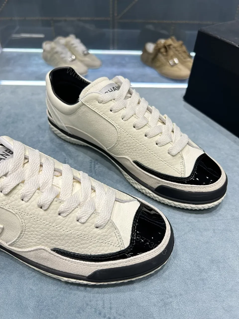 View 9 of Cream Leather Sneaker + Subtle Chanel-Inspired Detail + High-Top Comfort + Timeless Glossy Toe + Sneaker