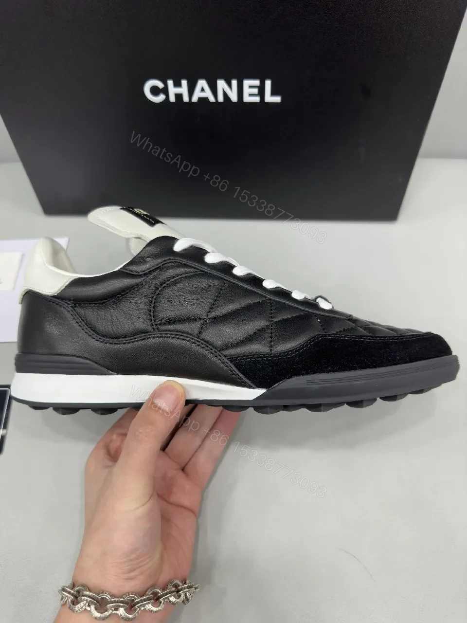 View 6 of Black-and-White Quilted Leather Sneakers with Luxe Hardware