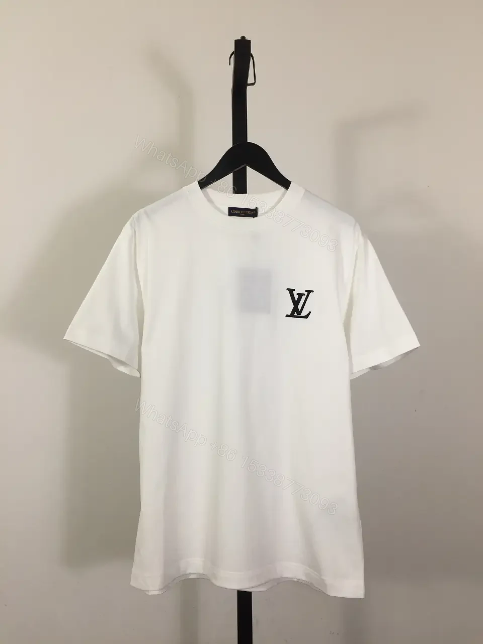 View 2 of Classic White Tee - Premium Cotton, Subtle Emblem, Everyday Luxe