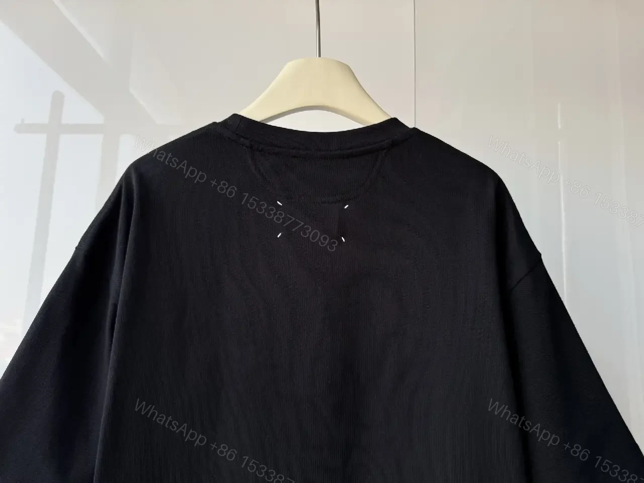 View 4 of Oversized Black Tee with Embossed Numeric Grid - Modern Graphic Comfort