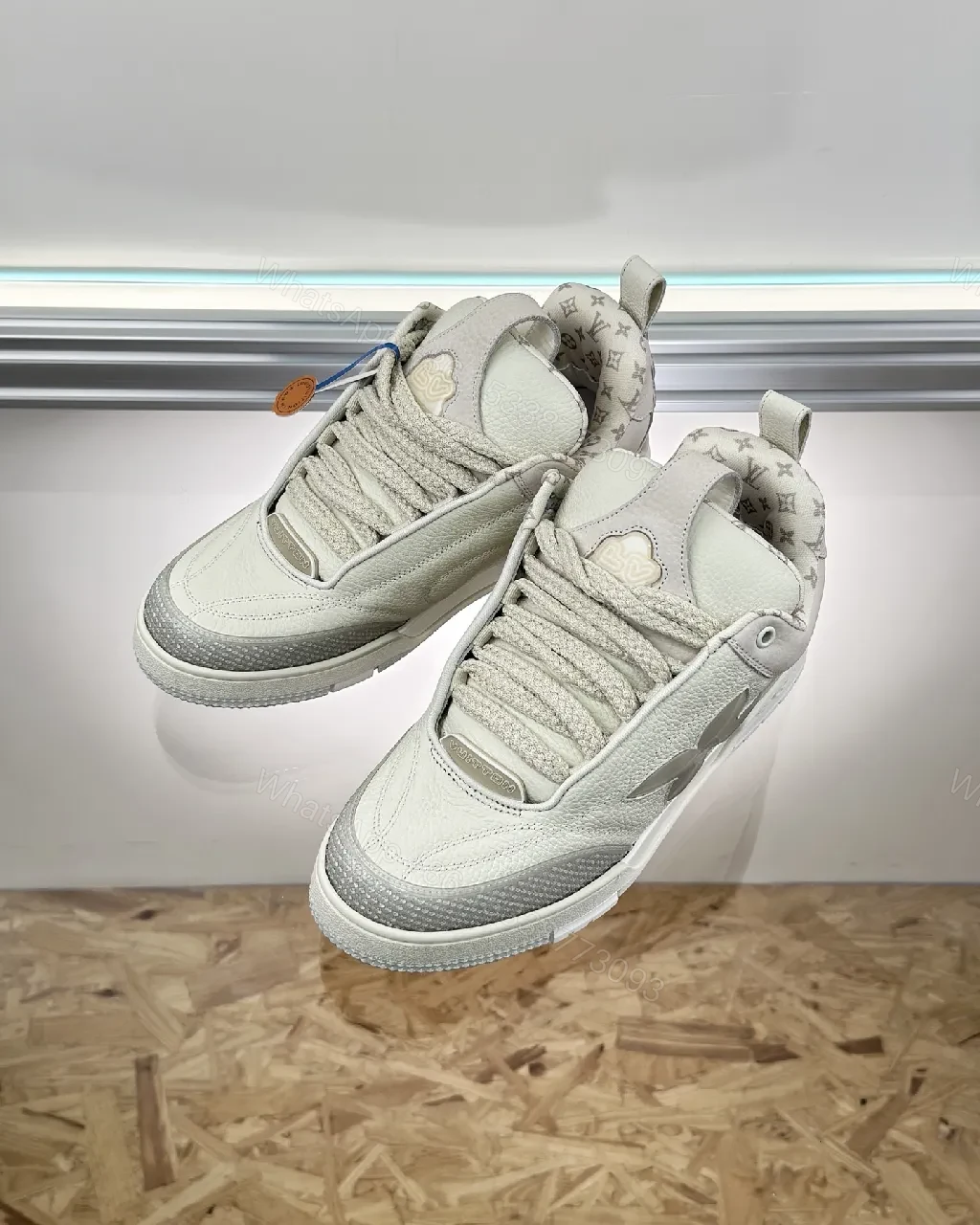 View 7 of Textured White Leather Sneakers with Signature Motif, Modern Luxury
