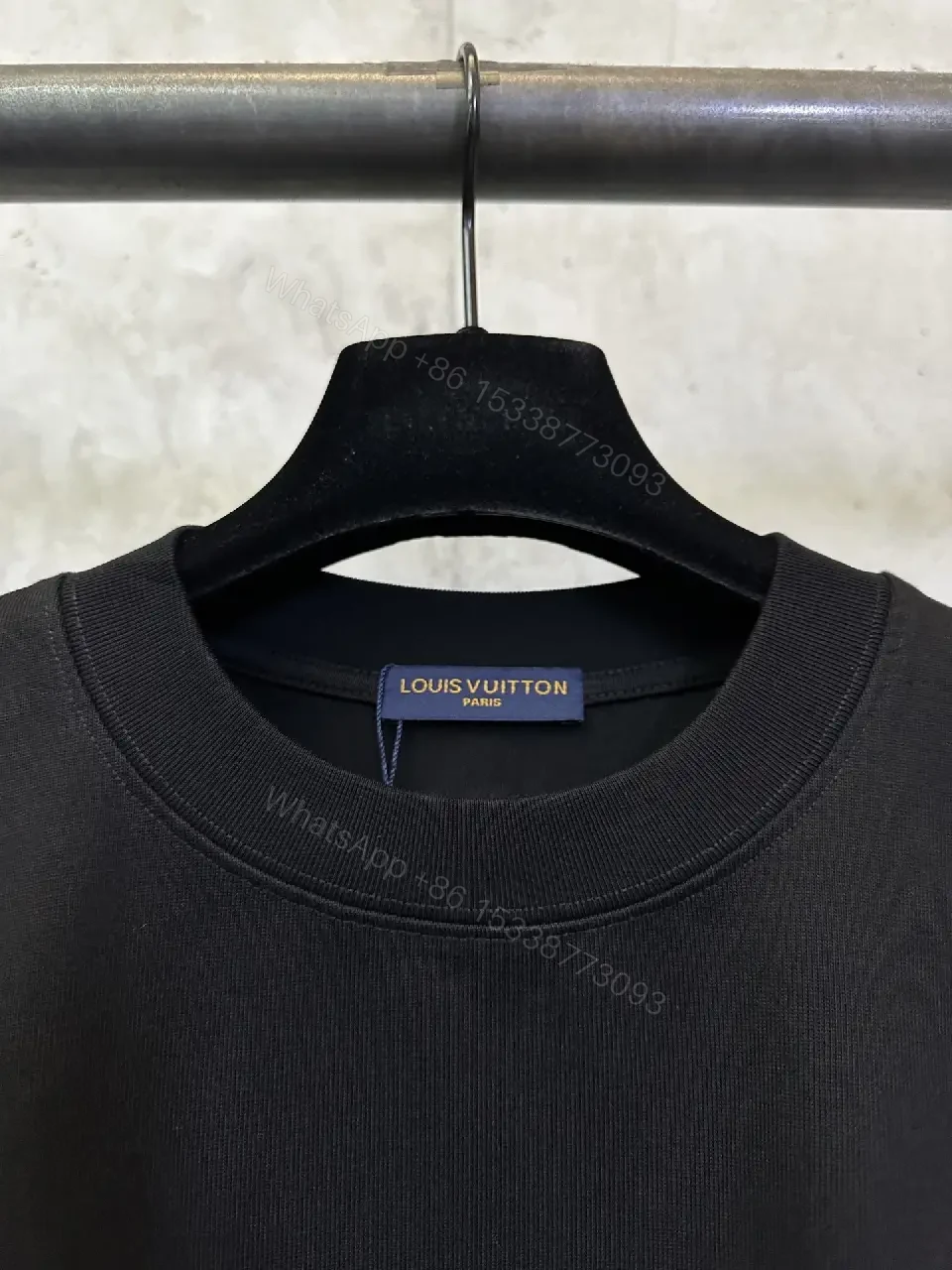 View 6 of Minimalist Black Tee with Subtle LV.M Emblem, Lux Cotton