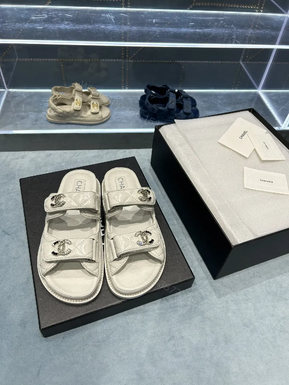 Chic White Sandals with Quilted Straps and Logo Hardware — view 1