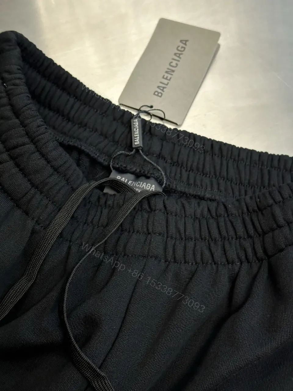View 6 of Chic Black Wide-Leg Track Pants with Subtle Logo