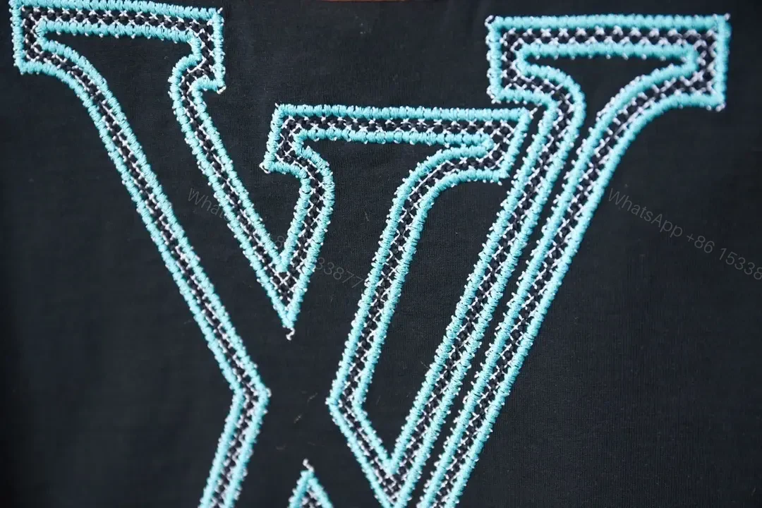 View 5 of Black Cotton Tee with Teal Embroidered Logo Accent, Minimalist Style, Everyday Luxury Tee